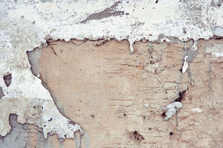 Texture of the surface of the old wall with a broken out of moisture, lots of cracks, unevennesses,...