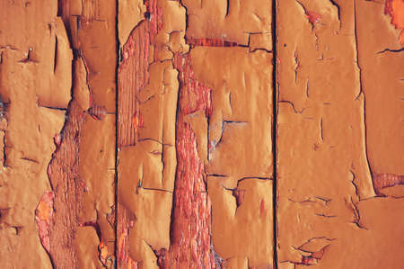 Old wooden background colored paint with cracks, scratches and abrasions.