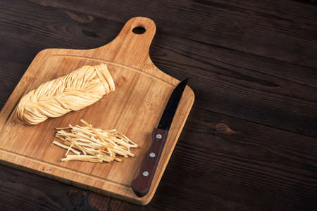 Delicious smoked wicker cheese on a wood background.の写真素材