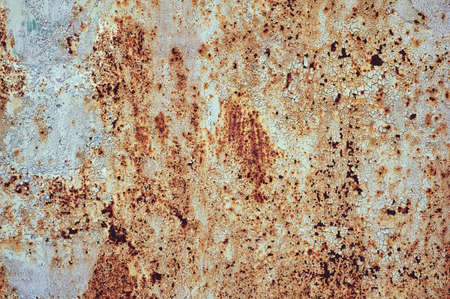 An old painted sheet of iron covered with rust. Abstract background. Grunge background