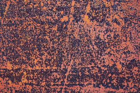 An old painted sheet of iron covered with rust. Abstract background. Grunge background