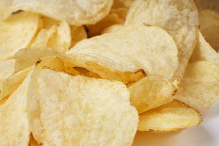 Delicious golden potato chips close-up. Food background.