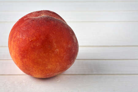 Delicious peaches on a white wooden background. Food background.