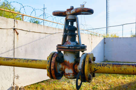 Older rusty valve on the gas pipe rusty yellow colored paint.の写真素材