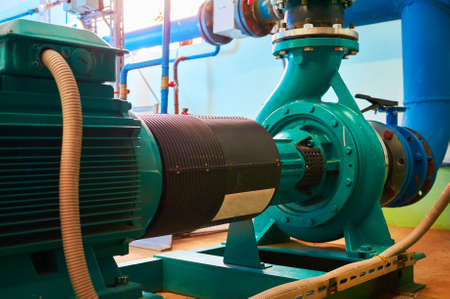 Blue motor pump standing on a metal stand.