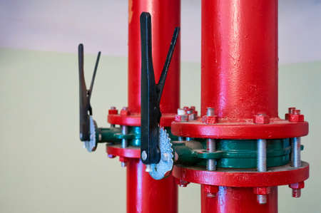 Gate valves installed on pipes painted in red. Industrial background.の写真素材