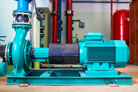 Blue motor pump standing on a metal stand.