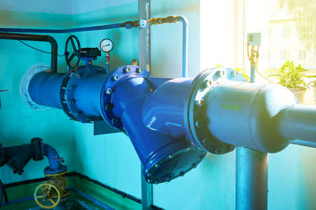 Gate valves installed on pipes painted in blue. Industrial background.の写真素材
