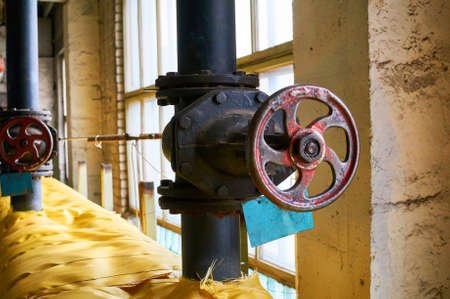 Two big black gate on the heating pipe isolated yellow cloth.