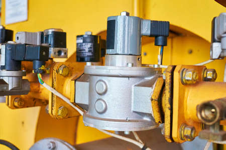 Gas pressure regulator in the conduit colored yellow.