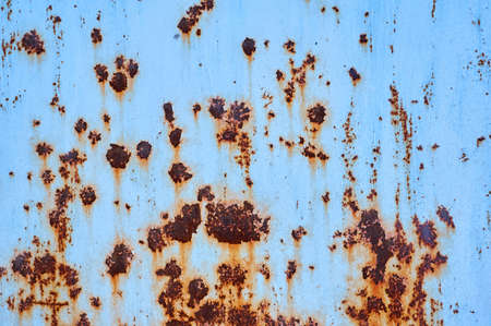Old metal shield painted with blue paint with rust.の写真素材