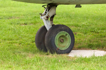 Old chassis of an old airplane close up on a background of green grass.の写真素材