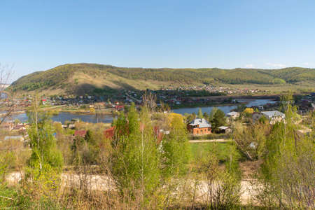 Small town on the background of the river and mountains.の写真素材