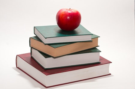 The red apple lies on the old bookの写真素材