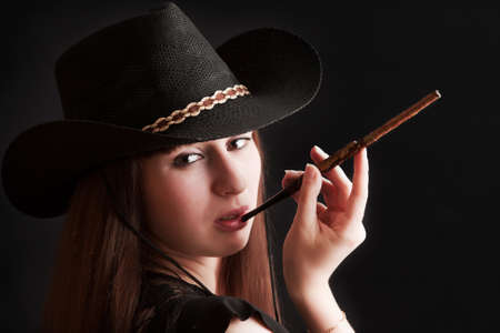 The girl in a cowboy s hat and with a mouthpieceの写真素材