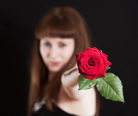 The girl in a black dress with a red roseの写真素材