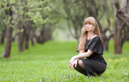 The girl sitting on a grassの写真素材