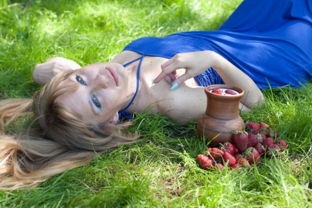 The woman with milk and a strawberryの写真素材