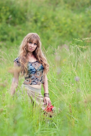 The beautiful girl of hippie costs in a high grass  の写真素材