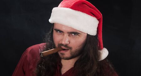 long-haired man in a Christmas hatの写真素材