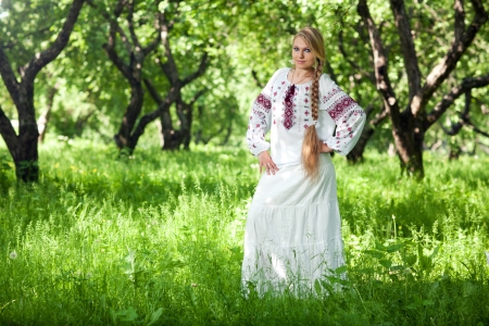 beautiful young peasant girl with a long braidの写真素材
