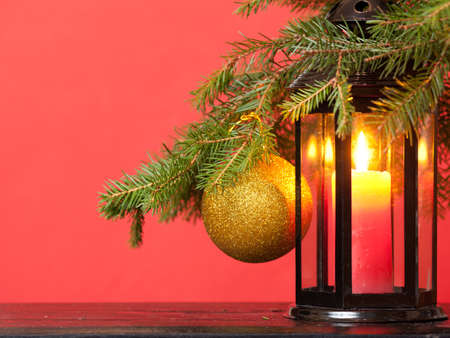 candle lantern, toys and Christmas tree on a red backgroundの写真素材