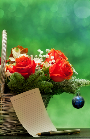 Bouquet of flowers with a note in a basket on a green background with beautiful bokehの写真素材