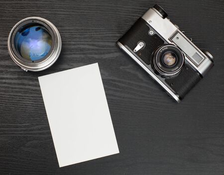 Photo and old camera on a wooden table. Blank Photoの写真素材