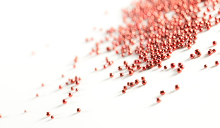 Beautiful small metal balls on a white background. Abstract background red colorの写真素材