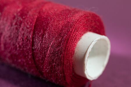 Spool of red thread closeup. Macro photo thread