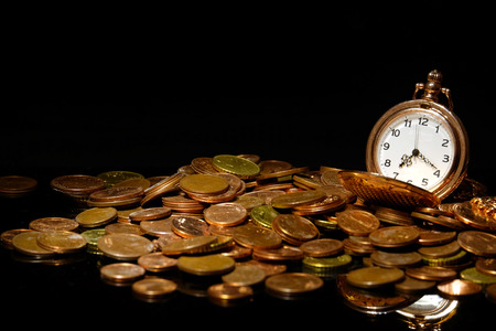 Pocket watch and coins on black background closeupの写真素材