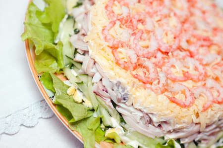 Salad with shrimp and cheese on the tableの写真素材