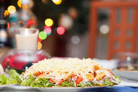 Beautifully decorated Caesar salad on the tableの写真素材