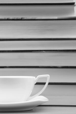 Cup of coffee and a stack of booksの写真素材