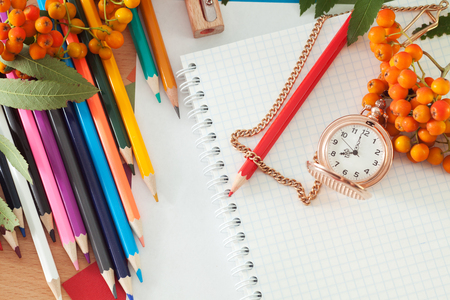 Colored pencils and a notebook on the table. Photos school suppliesの写真素材