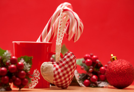 Christmas candies in a mug on a red backgroundの写真素材