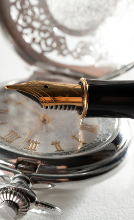 Beautiful fountain pen and pocket watch close-upの写真素材