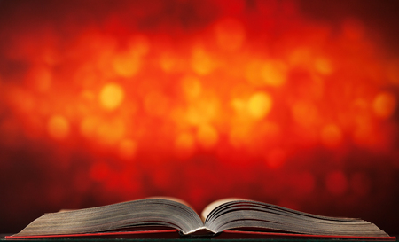 Big open book on bright background with bokehの写真素材