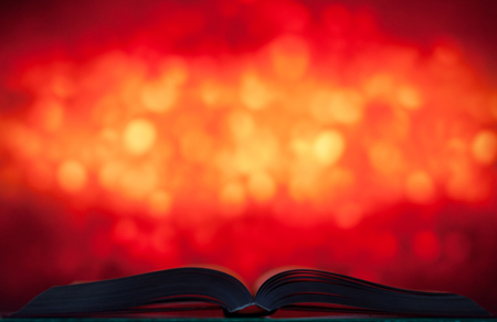 Big open book on bright background with bokehの写真素材