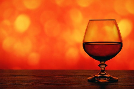 Brandy glass on the bright blurred background with bokehの写真素材
