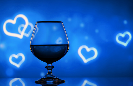 Brandy glass on the bright blurred background with bokehの写真素材