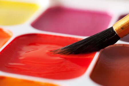 Colored paints and brushes close up. Photo of water colorsの写真素材