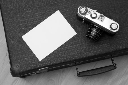 Photos and an old retro camera on a suitcaseの写真素材
