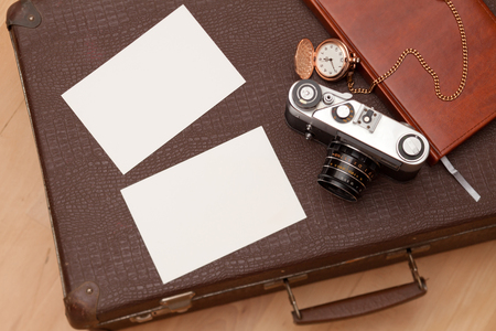 Photos and an old retro camera on a suitcaseの写真素材
