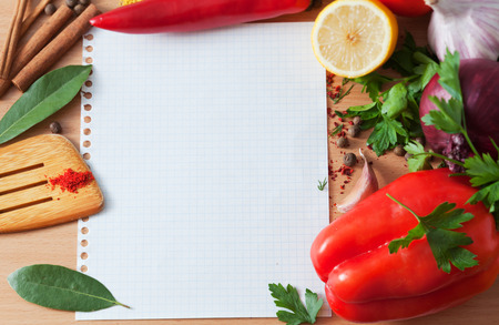 Ingredients for a dish and a sheet of paper on a tableの写真素材