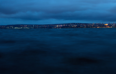 City at night on the other side of the lakeの写真素材