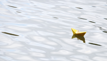 Paper boat on the waterの写真素材