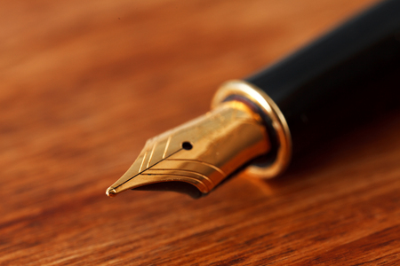 Fountain pen close-up on a wooden tableの写真素材