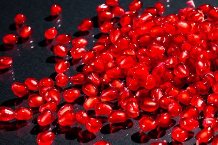 many juicy ripe red pomegranate seeds close-up