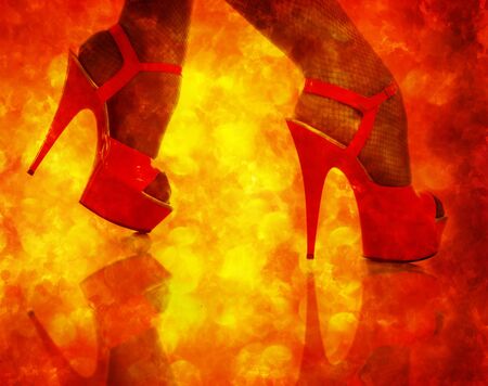 Female feet in red shoes with a high stiletto on a white backgroundの写真素材
